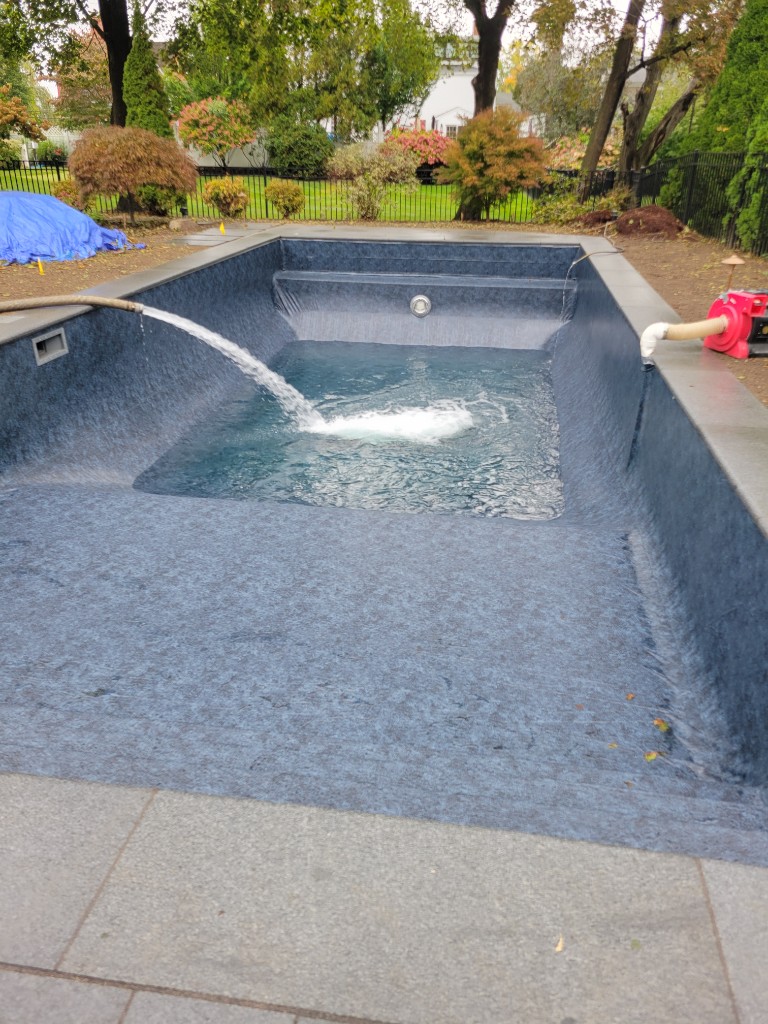 In-ground vinyl liner being filled after installation